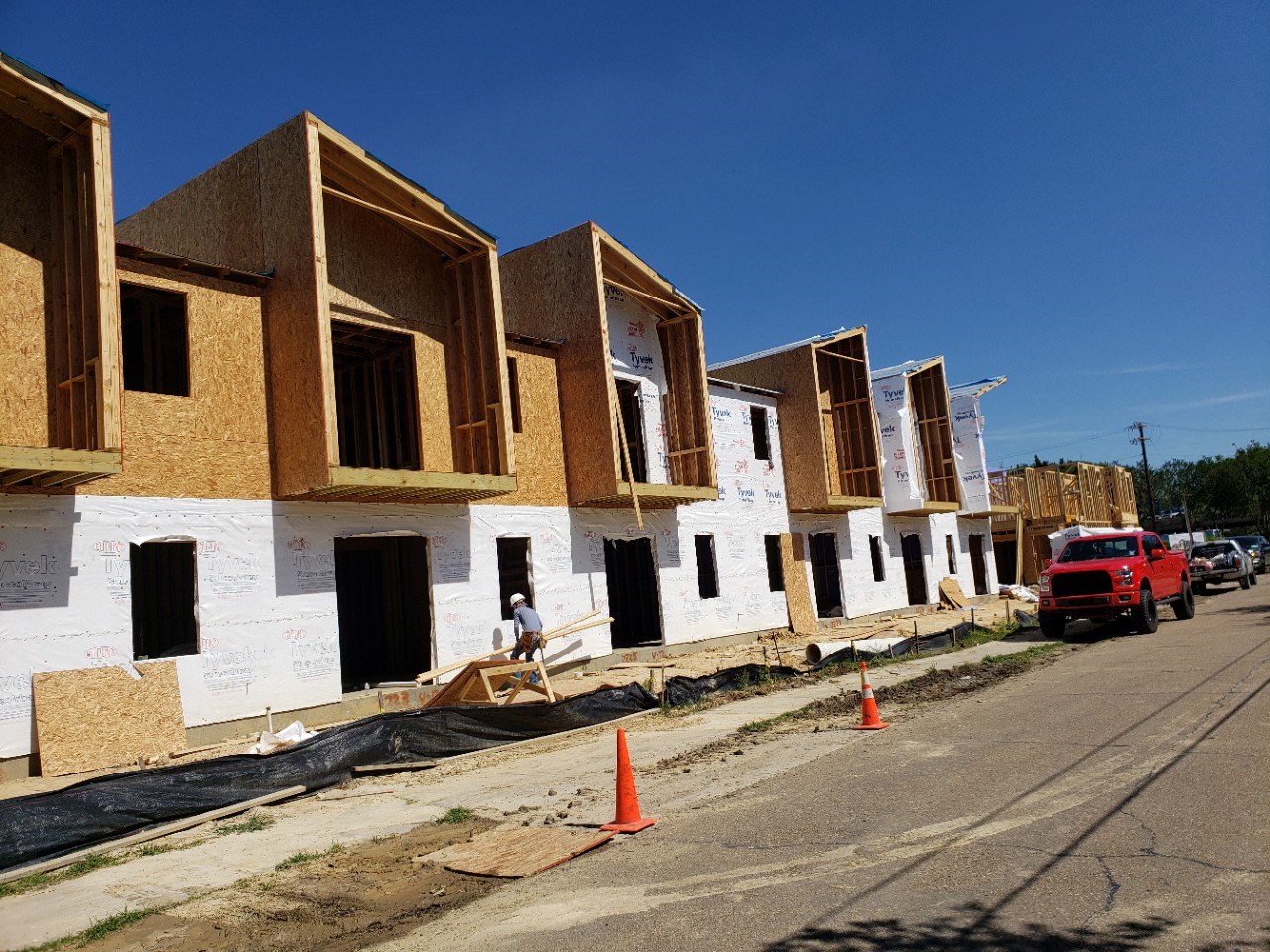 A row of multi-family townhomes under construction