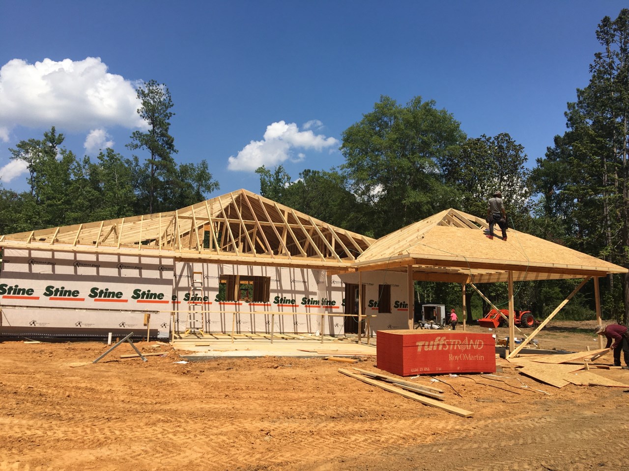Wood roof trusses and framing rising on a custom home at 31 Hunters Lane, Woodworth